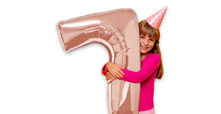 Girl hugging giant number balloon